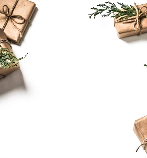 Drie kerstdoos verpakkingen, zorgvuldig ingepakt in bruin papier en voorzien van kersttak