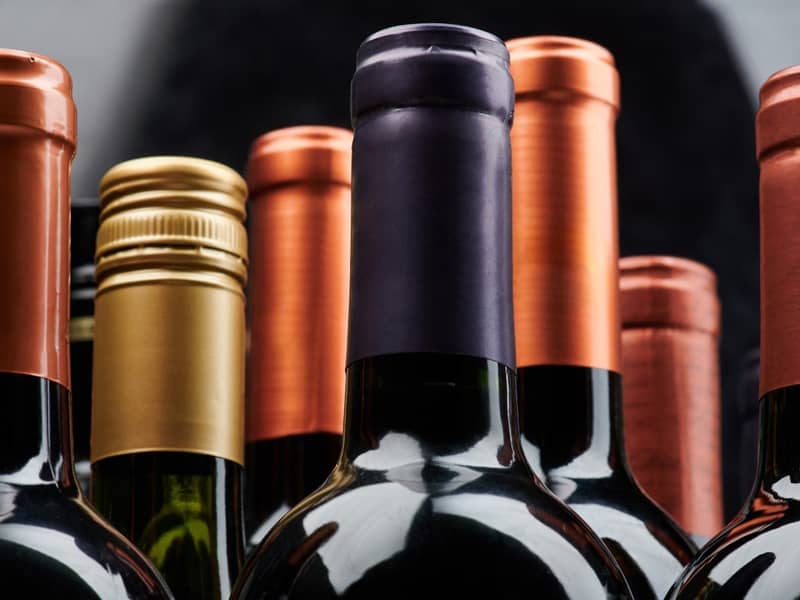 Mehrere Flaschenhälse von Weinflaschen.