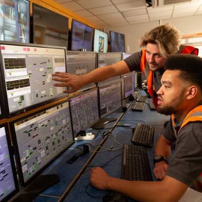two people observing data on a computer screen