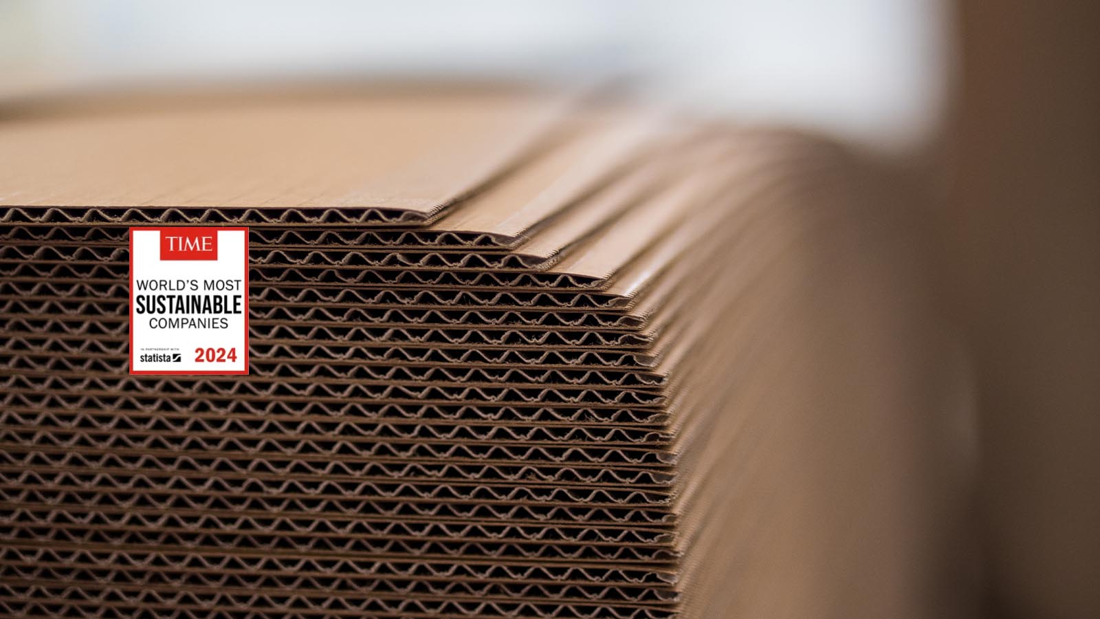 Logo Time Magazine World's most sustainable companies on pile of brown cardboard