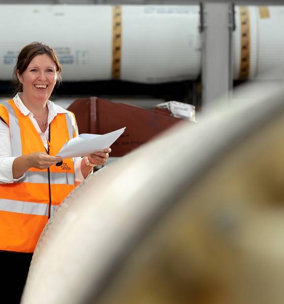 A person in a high visibility jacket smiling