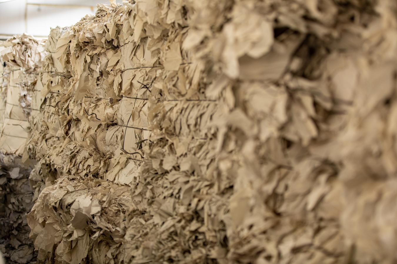 A close up photo of a bale of cardboard